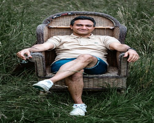 Mature man sitting comfortably in a warm setting looking confident